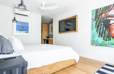 a bedroom with a bed and a tv on the wall at Simple La Jolla Epic bungalow #1 in San Diego