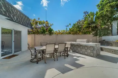 a patio with a table and chairs and a fence at Hey I Am Adriana On The Block Pool BBQ in Mission Viejo