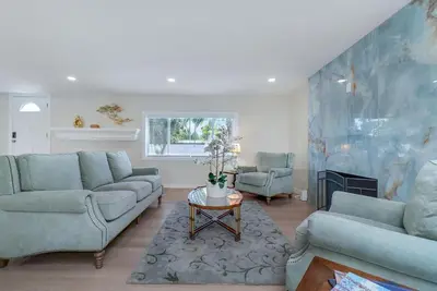 a living room with blue couches and a fireplace at Hey I Am Adriana On The Block Pool BBQ in Mission Viejo