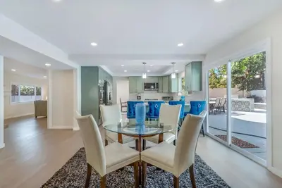 a dining room and kitchen with a glass table and chairs at Hey I Am Adriana On The Block Pool BBQ in Mission Viejo