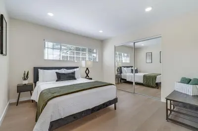 a bedroom with a large bed and a mirror at Hey I Am Adriana On The Block Pool BBQ in Mission Viejo