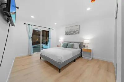 a white bedroom with a bed and a window at Entire Private Home with 4 Bedrooms 3 Bathrooms, Big Yard, View, , King Bed, 10 Parking, Available Now in El Cajon