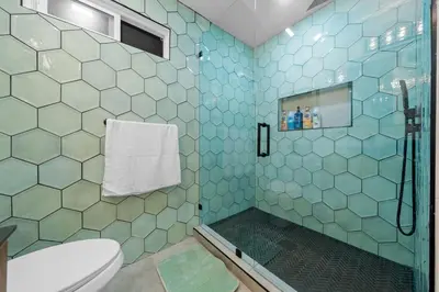 a bathroom with a toilet and a shower with blue tiles at Entire Private Home with 4 Bedrooms 3 Bathrooms, Big Yard, View, , King Bed, 10 Parking, Available Now in El Cajon