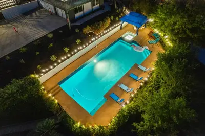 an overhead view of a swimming pool with chairs and lights at Entire Private Home with 4 Bedrooms 3 Bathrooms, Big Yard, View, , King Bed, 10 Parking, Available Now in El Cajon