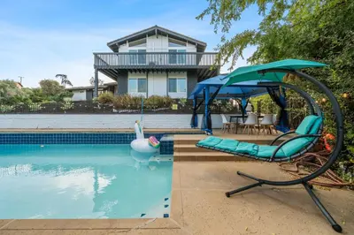 a pool with a swan and a chair and a swan umbrella at Entire Private Home with 4 Bedrooms 3 Bathrooms, Big Yard, View, , King Bed, 10 Parking, Available Now in El Cajon