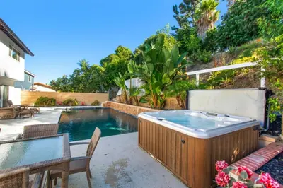 a swimming pool with a hot tub in a backyard at Lux MV Home Live Like A Local Backyard Oasis in Mission Viejo