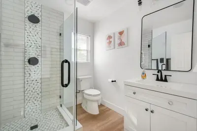 a bathroom with a toilet and a glass shower at Lux MV Home Live Like A Local Backyard Oasis in Mission Viejo