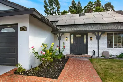 a house with a black door and some flowers at Lux MV Home Live Like A Local Backyard Oasis in Mission Viejo