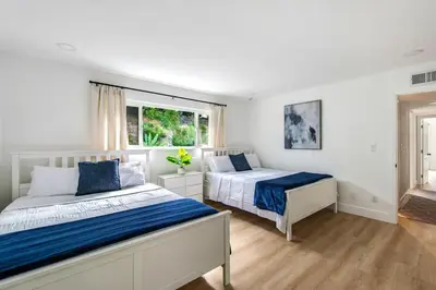a bedroom with two beds and a window at Lux MV Home Live Like A Local Backyard Oasis in Mission Viejo