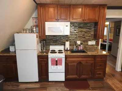 a kitchen with a white stove and a refrigerator at Historic Gold Town Loft A-Frame 1 Bedroom with sofa sleeper WIFI in Julian