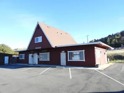 a large red building with a parking lot at Historic Gold Town Loft A-Frame 1 Bedroom with sofa sleeper WIFI in Julian