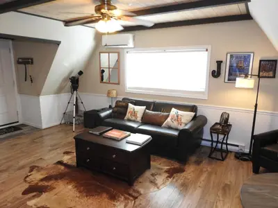 a living room with a leather couch and a table at Historic Gold Town Loft A-Frame 1 Bedroom with sofa sleeper WIFI in Julian
