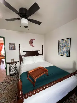 a bedroom with a bed with a ceiling fan at The Sisters Casitas Frida & Violeta - 2 FULL APTS in San Diego