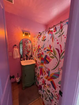 a bathroom with a shower curtain and a sink at The Sisters Casitas Frida & Violeta - 2 FULL APTS in San Diego