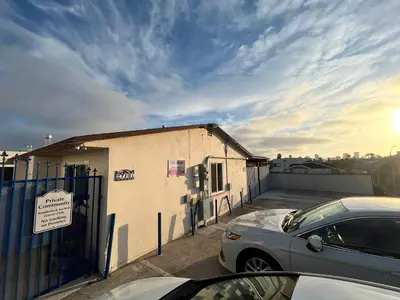 a building with a car parked in a parking lot at The Sisters Casitas Frida & Violeta - 2 FULL APTS in San Diego