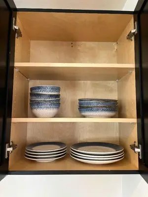 a cabinet with plates and bowls in it at The Sisters Casitas Frida & Violeta - 2 FULL APTS in San Diego