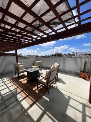 a pergola on a patio with two chairs and a table at The Sisters Casitas Frida & Violeta - 2 FULL APTS in San Diego