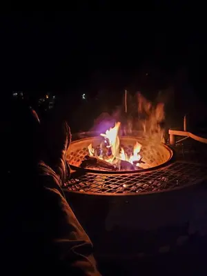 a fire pit at night with flames in it at Temecula Wine Country Ranch with 200 year old oaks in Temecula