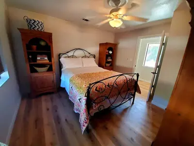 a bedroom with a bed and a ceiling fan at Temecula Wine Country Ranch with 200 year old oaks in Temecula