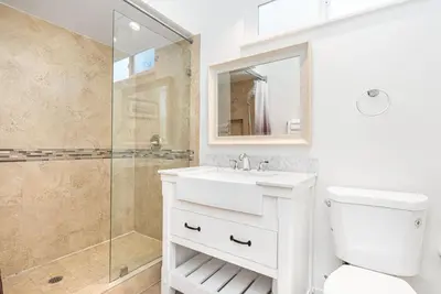 a white bathroom with a sink and a shower at 4Br Retreat One House From The Beach And Boardwalk By Beachview Rentals in Newport Beach