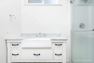 a white bathroom with a sink and a shower at 4Br Retreat One House From The Beach And Boardwalk By Beachview Rentals in Newport Beach
