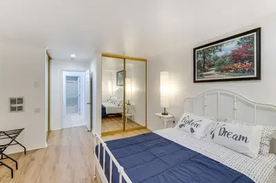 a bedroom with a bed and a mirror in a room at 1 Mi to PB Boardwalk Condo with Community Perks in San Diego