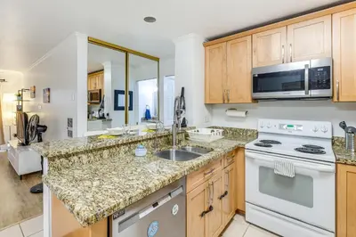 a kitchen with a sink and a stove at 1 Mi to PB Boardwalk Condo with Community Perks in San Diego