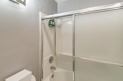 a bathroom with a shower with a glass door at 1 Mi to PB Boardwalk Condo with Community Perks in San Diego