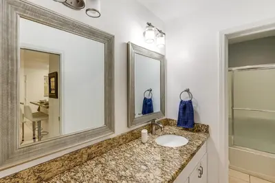 a bathroom with a sink and two mirrors at 1 Mi to PB Boardwalk Condo with Community Perks in San Diego