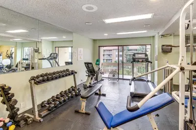 a fitness room with treadmills and machines at 1 Mi to PB Boardwalk Condo with Community Perks in San Diego