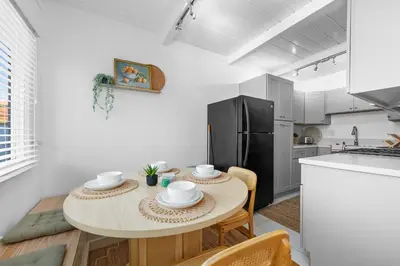 a small kitchen with a table and a refrigerator at Modern Eclectic 2BR Near Petco, Balboa Park & Zoo in San Diego