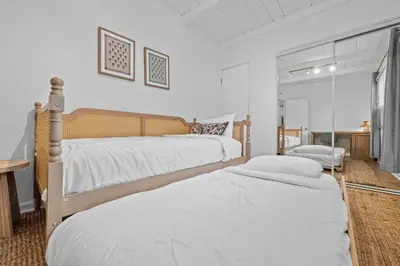a bedroom with two beds and a desk in it at Modern Eclectic 2BR Near Petco, Balboa Park & Zoo in San Diego