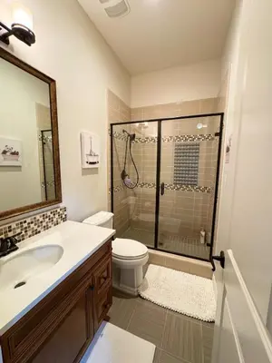 a bathroom with a shower and a toilet and a sink at Vineyard Vista Retreat in Temecula
