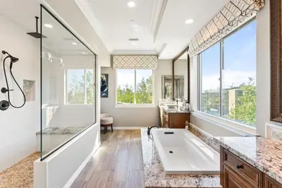 a bathroom with a tub and a large window at Vineyard Vista Retreat in Temecula