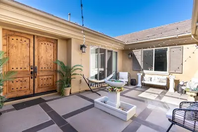 a patio with a bench and a fountain on a house at Vineyard Vista Retreat in Temecula