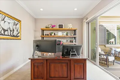 a home office with a desk with a television at Vineyard Vista Retreat in Temecula