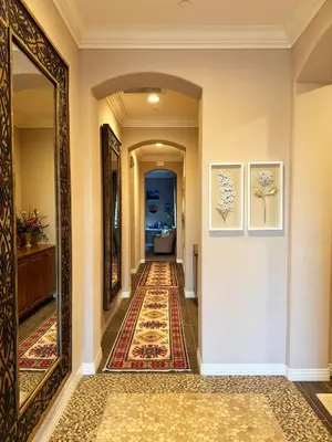 a hallway with a mirror and a rug at Vineyard Vista Retreat in Temecula