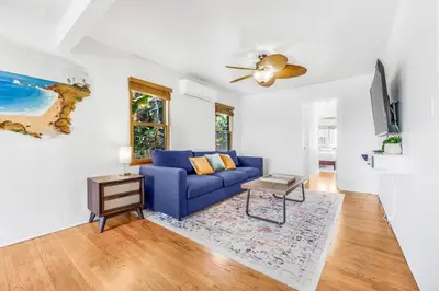 a living room with a blue couch and a table at 2BR-2 mins to Ocean-Sleeps 8-Pets in San Diego
