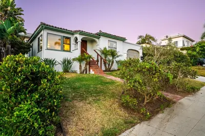 a white house with a green roof at 2BR-2 mins to Ocean-Sleeps 8-Pets in San Diego