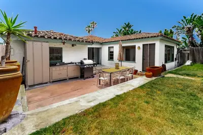 a backyard with a patio with a table and a kitchen at 2BR-2 mins to Ocean-Sleeps 8-Pets in San Diego