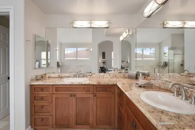 a bathroom with two sinks and a large mirror at Windansea Hideaway Rooftop Ocean Views in San Diego