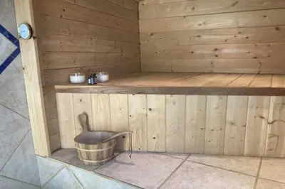 a wooden sauna with a bucket in the middle at Cozy Cabin Hot Tub Sauna Fireplace in Palomar Mountain