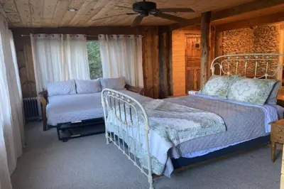 a bedroom with a bed and a couch at Cozy Cabin Hot Tub Sauna Fireplace in Palomar Mountain