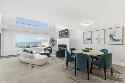 a living room with a table and chairs at Sea Glass Beach Road Villa On the SAND Luxury and relaxation in Dana Point
