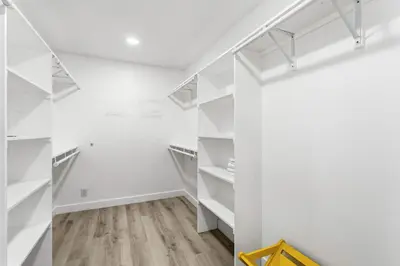 an empty room with white shelves and wood floors at Sea Glass Beach Road Villa On the SAND Luxury and relaxation in Dana Point