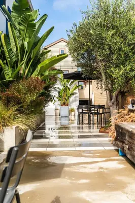 a patio with tables and chairs and plants at Simple La Jolla Epic bungalow # 3 in San Diego