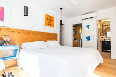 a white bedroom with a large white bed at Simple La Jolla Epic bungalow # 2 in San Diego