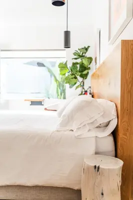 a bedroom with a bed with a wooden headboard at Simple La Jolla Epic bungalow # 2 in San Diego