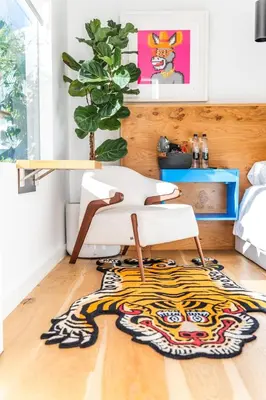 a room with a white chair and a rug at Simple La Jolla Epic bungalow # 2 in San Diego