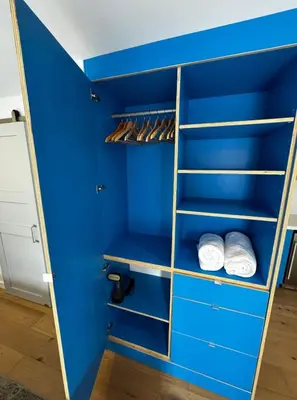 a blue closet with shelves and white towels at Simple La Jolla Epic bungalow #7 in San Diego